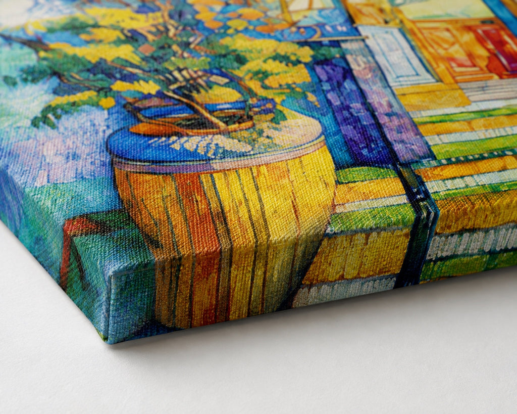 Close-up of a colourful gallery-wrapped canvas print showing the textured woven surface, crisp folded corner and printed edge detail in vibrant blue, yellow, orange and green tones