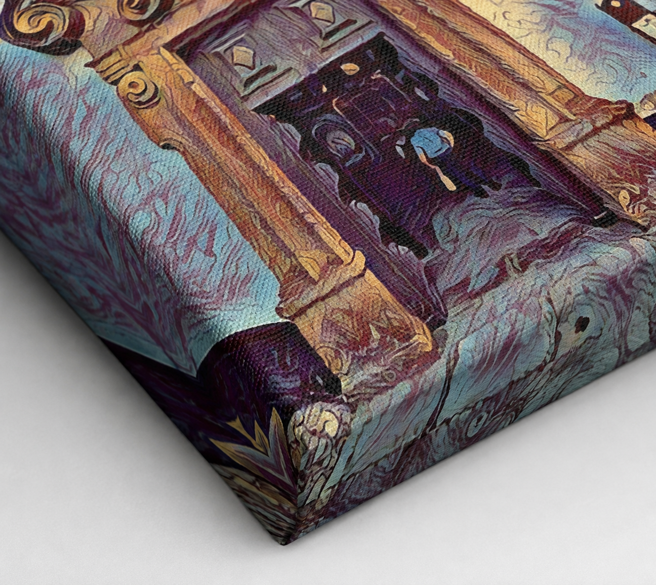 Close-up detail of a gallery-wrapped canvas print showing the textured woven surface, crisp folded corner and artwork continuing around the edge in rich plum, ochre and blue tones.